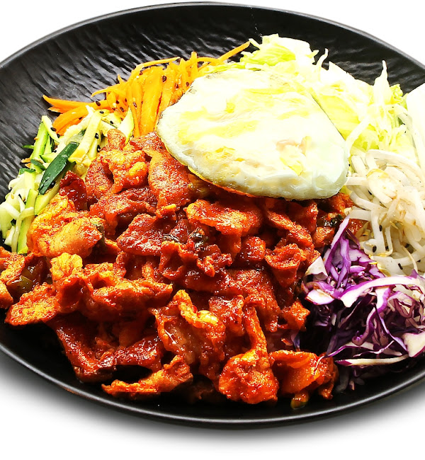 Spicy marinated pork with vegetables and fried egg on rice